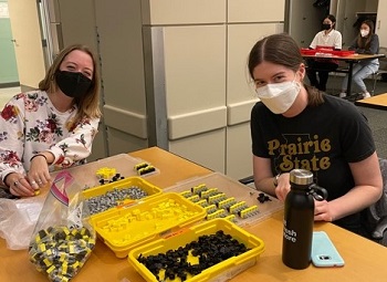 two women at a table building a protein kit