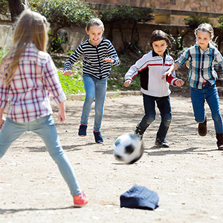 children playing soccer outdoors