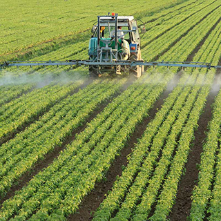 farm equipment spraying field of crops