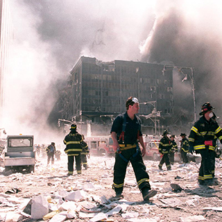 firemen walking through debris and smoke from the World Trade Center destruction