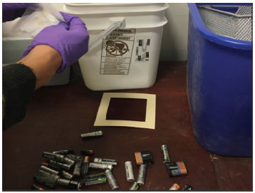 Students sample surfaces for metals at an electronic recycling facility