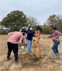trainees clearing land with shovels on the farm