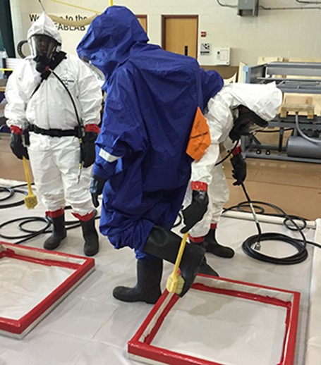Trainees run through a simulation of a decontamination line in Flint, Michigan. (Photo courtesy of Howard Hipes, CPWR)
