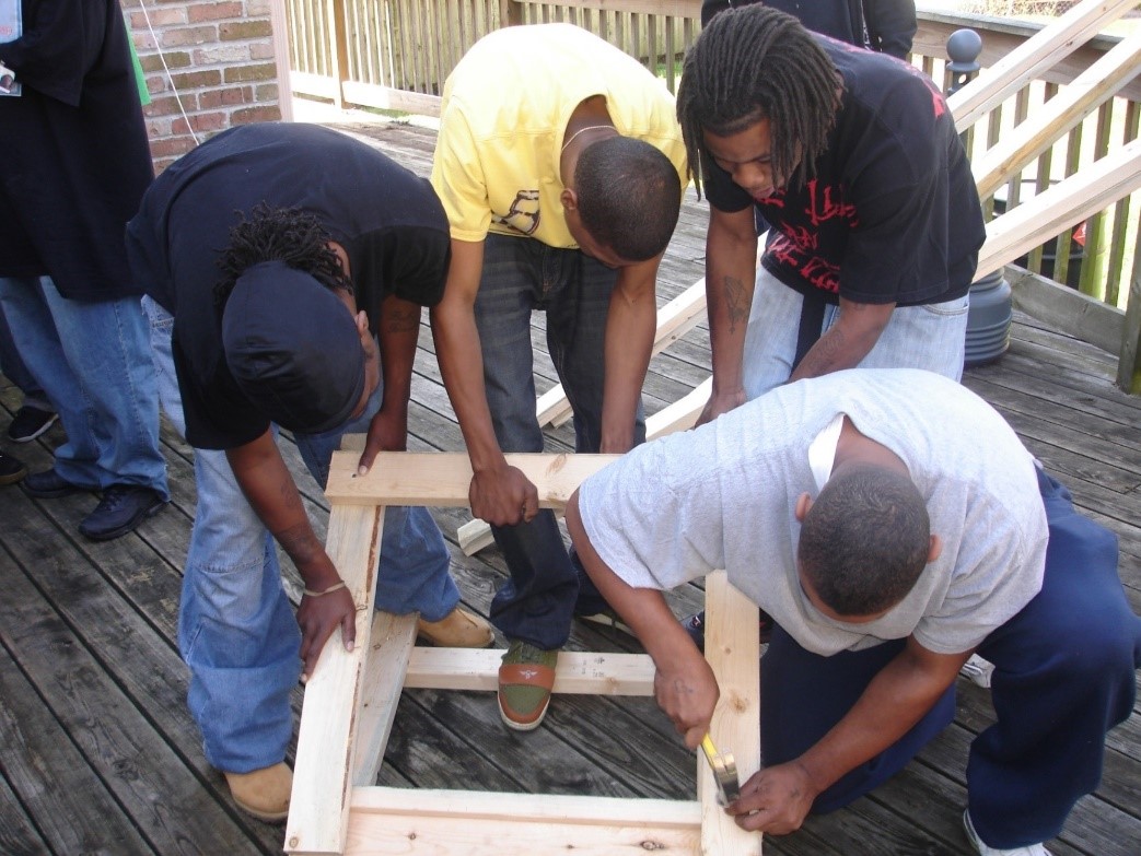 Trainees learning new skills during a basic construction course. (Photo courtesy of Deep South Center for Environmental Justice). 