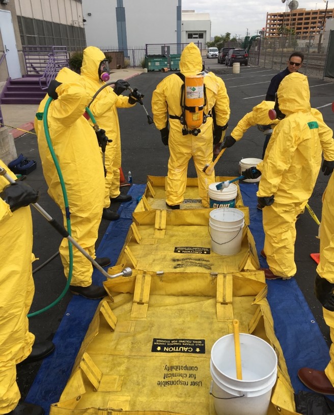 Trainees learn to decontaminate HAZMAT suits. (Photo courtesy of Western Region Universities Consortium).